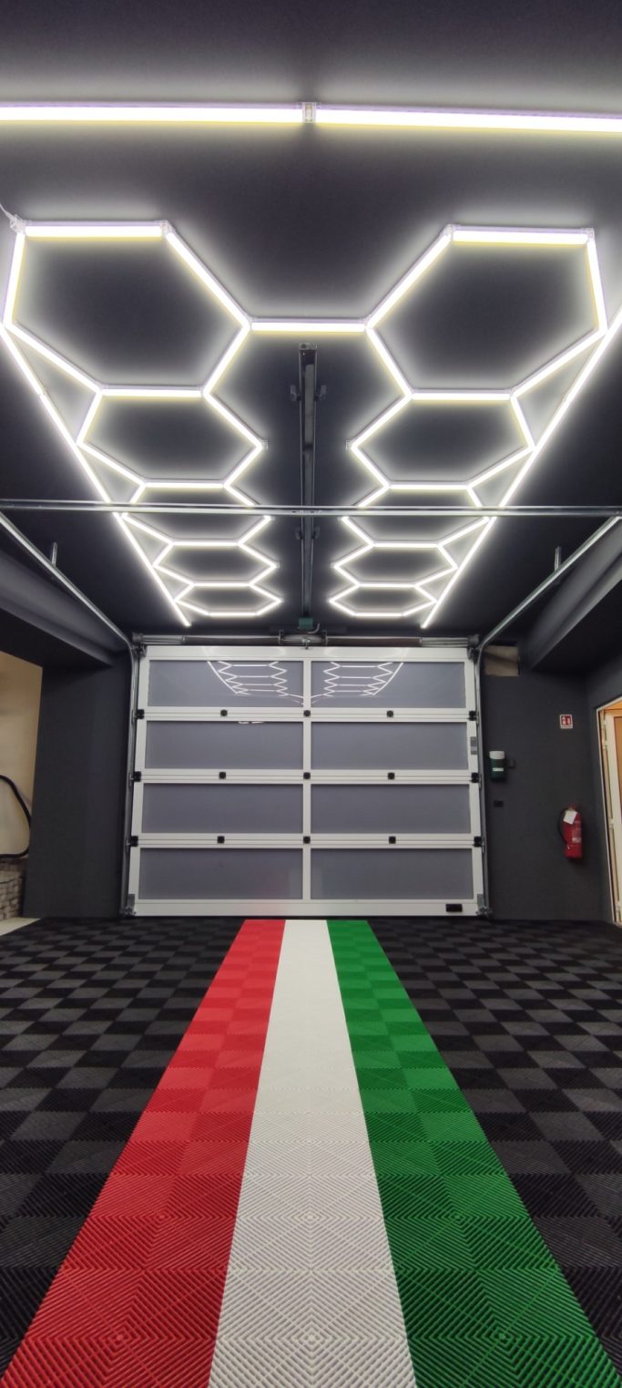 Modern interior with hexagonal lights and a striped tricolor floor design.