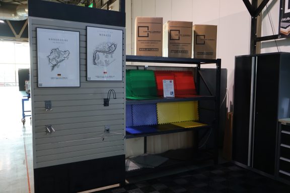 Mobile shelving unit with colorful bins and instructional posters on the side.