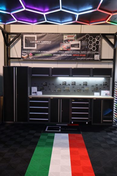 Laboratory workspace with black cabinets, high-tech features, and an Italian flag motif on the floor.