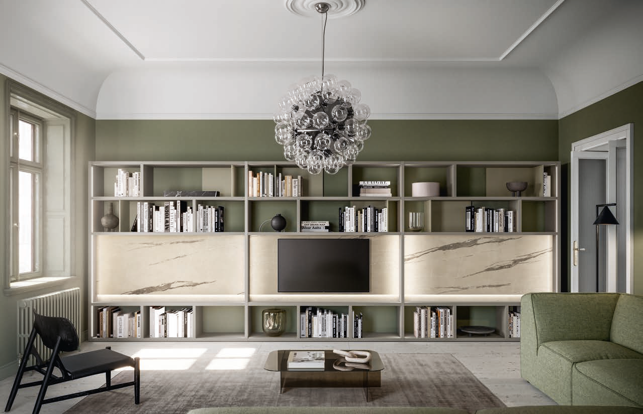 COMPOSIZIONE PISTACCHIO Modern living room with green walls, stylish shelving, a TV, and a unique chandelier.