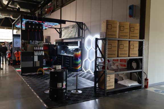 Stand featuring colorful decorations, storage boxes, and equipment for demonstrations.