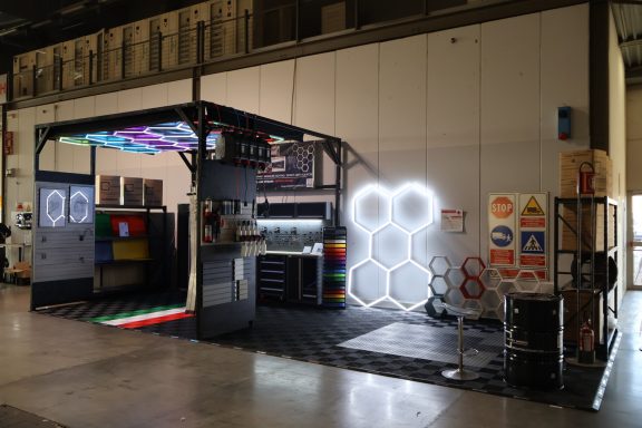 Modular exhibition booth with colorful lighting and hexagonal design elements.