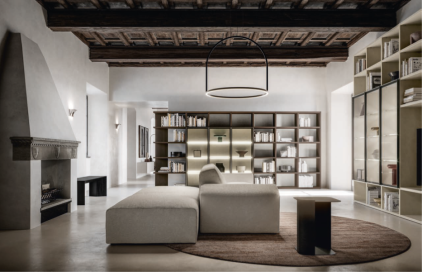 MODERN LIVING Modern living room with a cozy sofa, bookshelf, and rustic wooden beams on the ceiling.