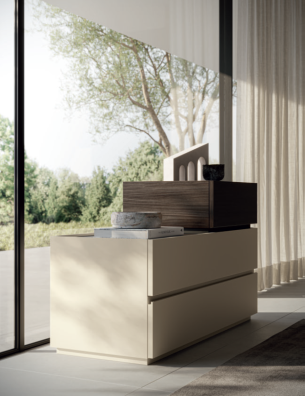 CASSETTIERA Modular storage unit with a beige base and a dark wood top, placed by large windows.