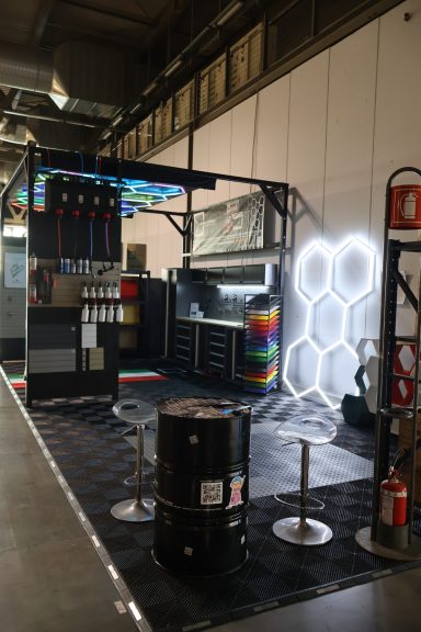 Modular display area featuring tools, barrels, and illuminated hexagonal design.