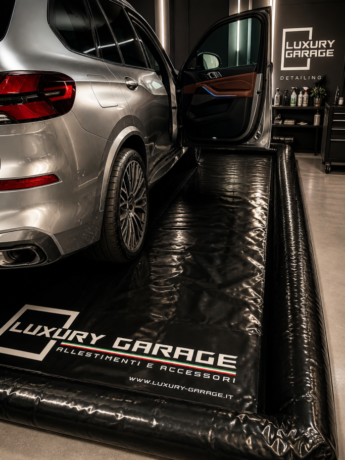 SUV parked inside a luxury garage with a sleek black floor mat.