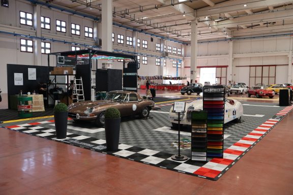 A large indoor display featuring classic cars and a race-themed setup.