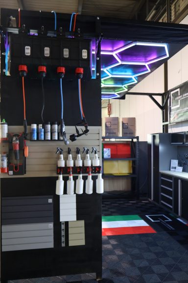 Area with equipment and colorful hexagonal lights, featuring dispensing units and storage.